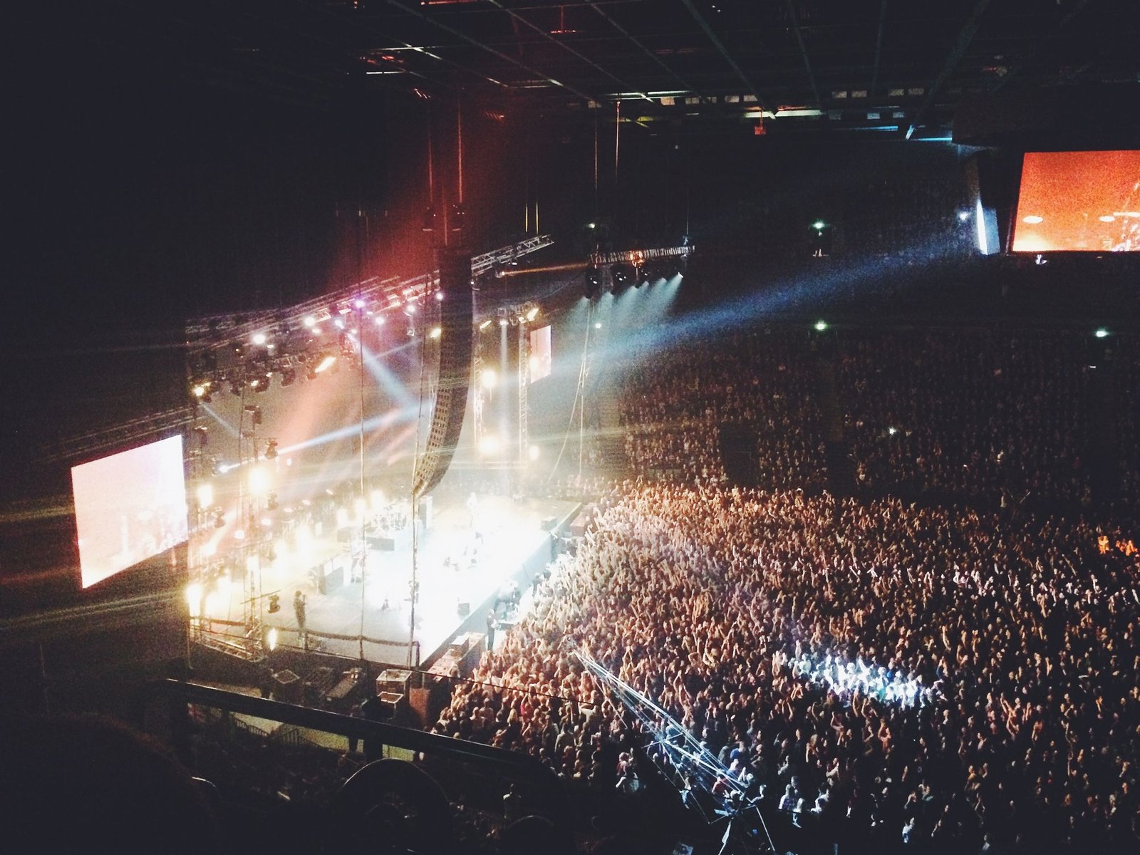 Packed arena under stage lights