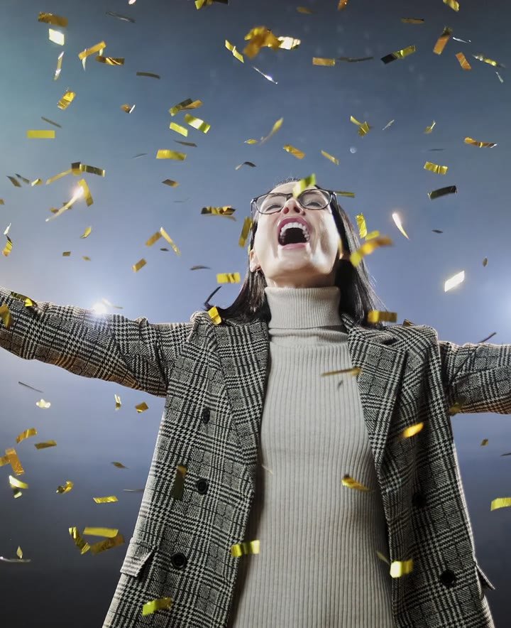 Alexandra celebrating on stage as confetti falls